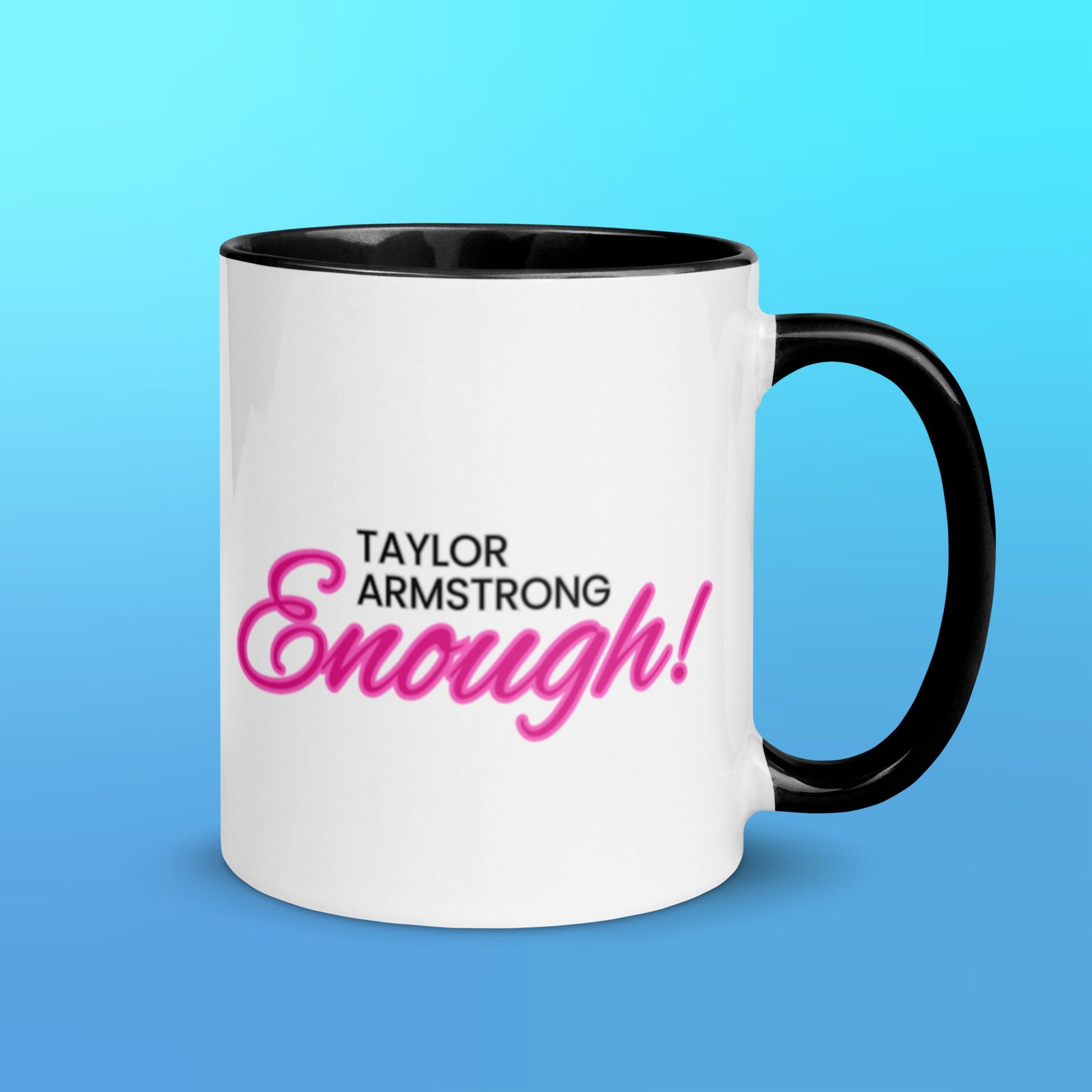 A white mug with a black handle and black interior with the phrase Taylor Armstrong ENOUGH! written in black and pink font in the center.