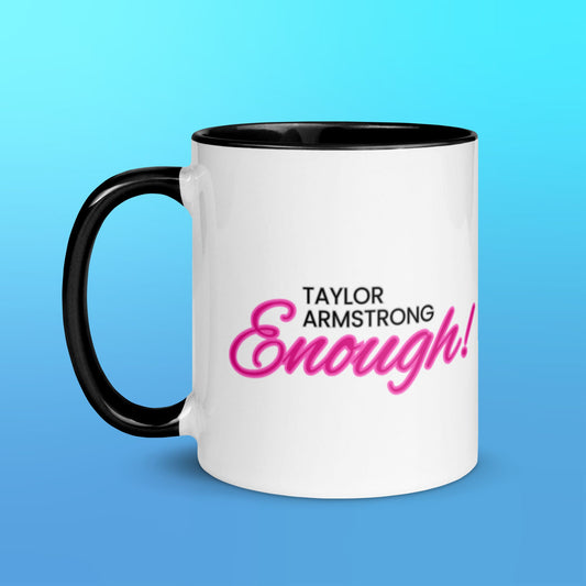 A white mug with a black handle and black interior with the phrase Taylor Armstrong ENOUGH! written in black and pink font in the center.