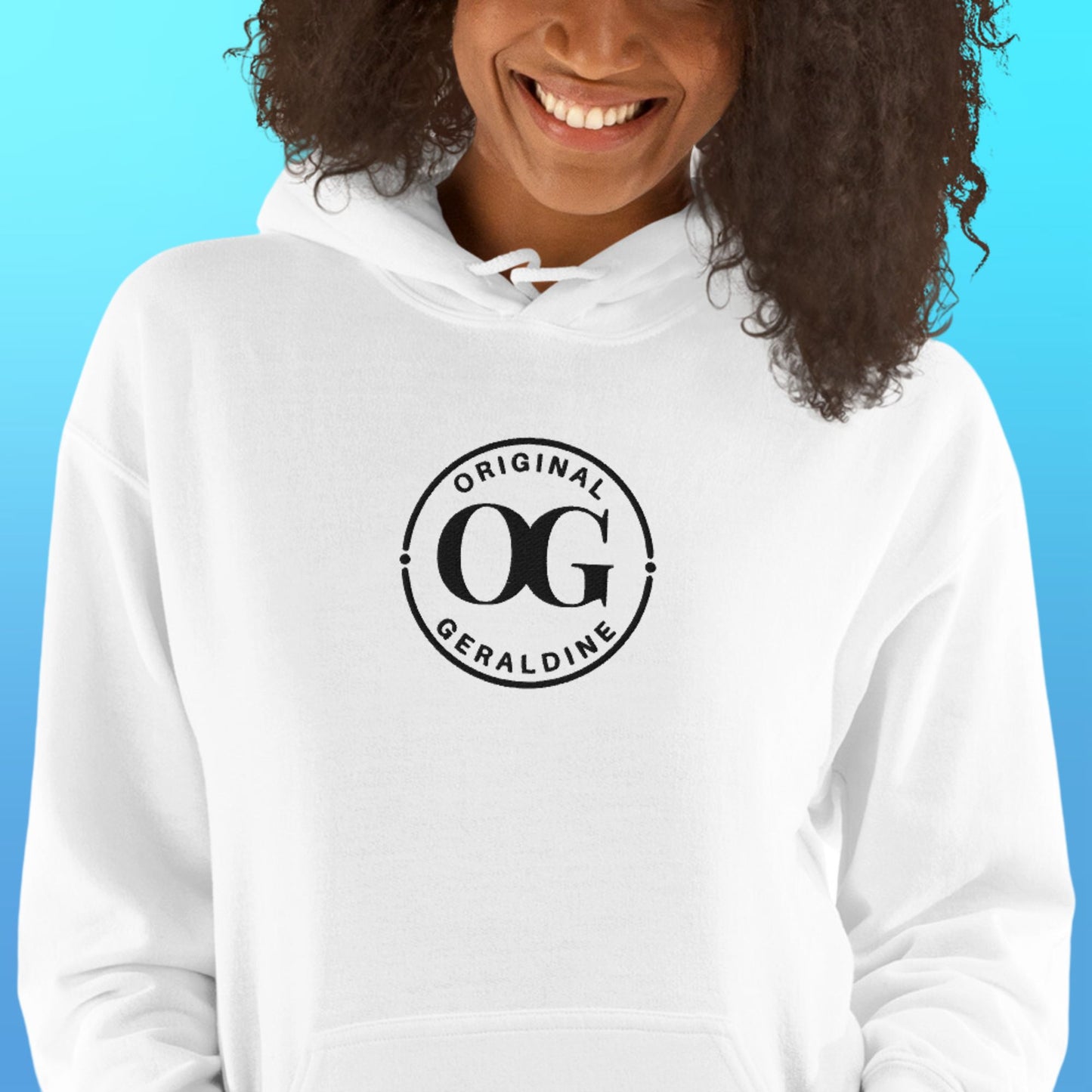 A person wearing a white pullover hoodie with front pocket pouch with OG Original Geraldine emroidered in black thread on the center front.